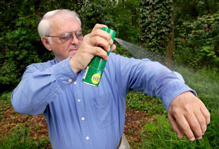 Man using bug repellant