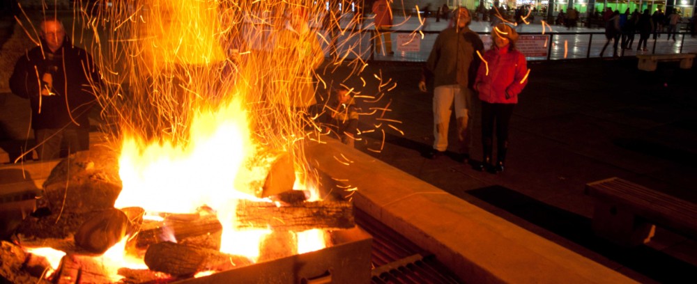 Skaters warming by Steinberg Rink's fire