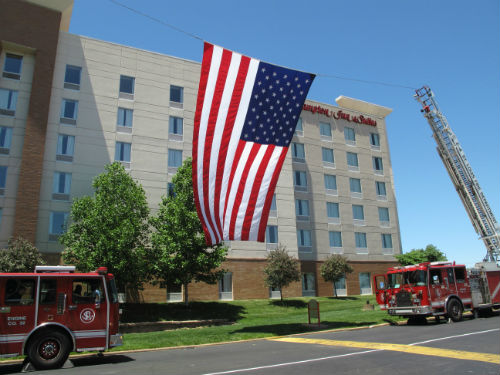 The American Flag is displayed outside the Mildred E. Bastian Theatre on the campus of St. Louis Community College at Forest Park on May 24, 2013.