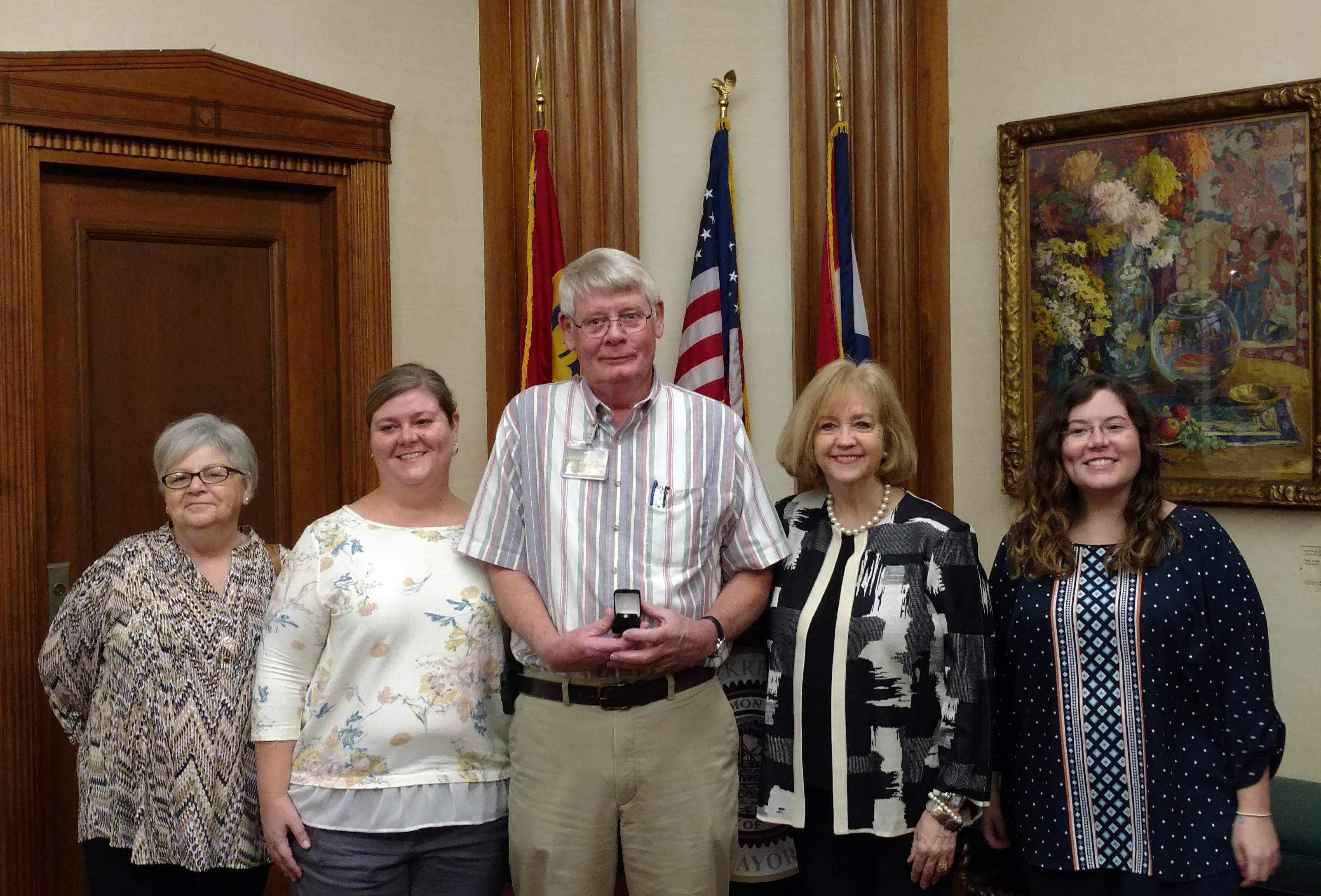 Members of the Huelman Family post with Mayor Krewson after the service pin presentation