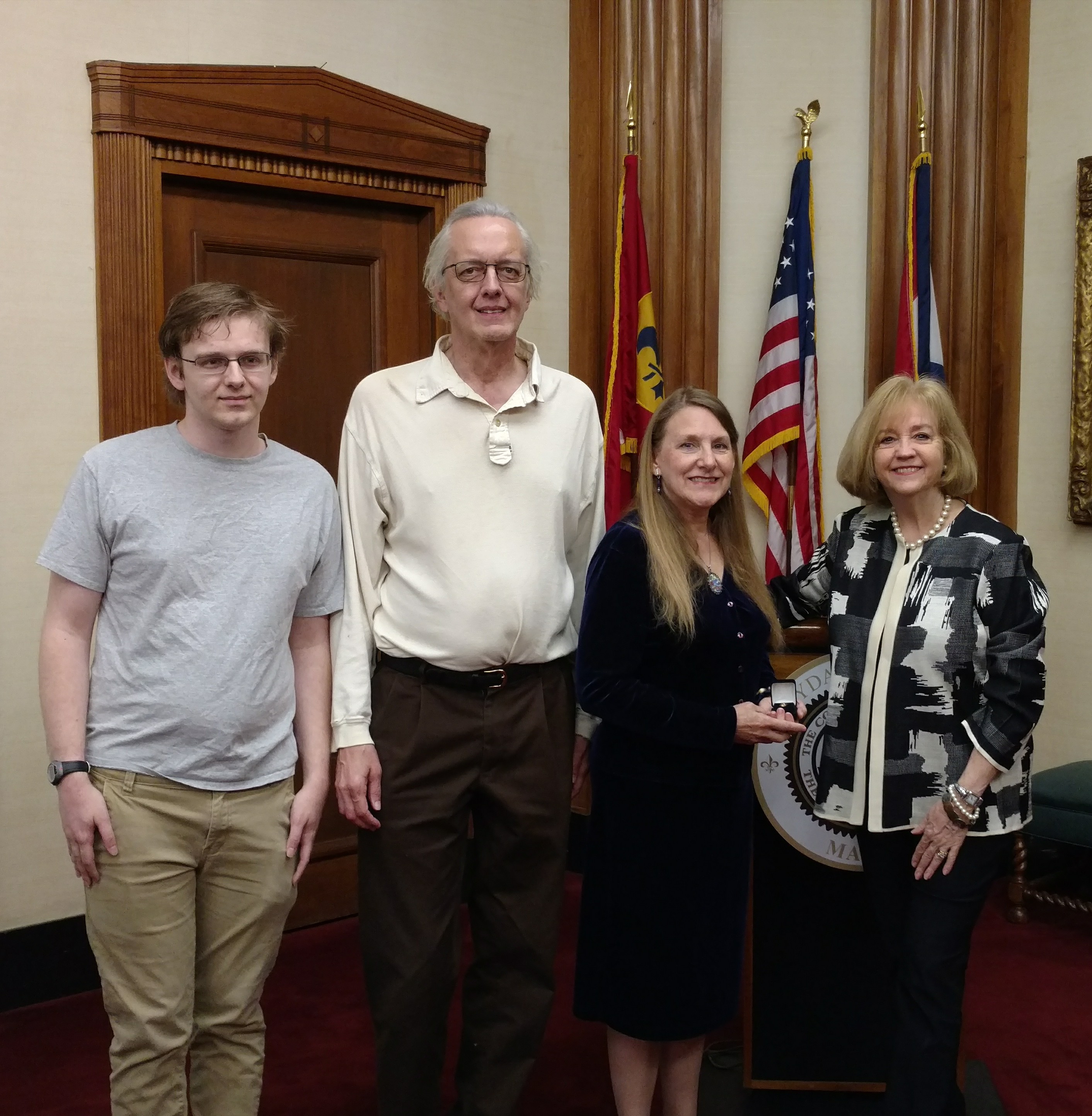 Kathy Doerr receives her 40-year service pin from Mayor Lyda Krewson