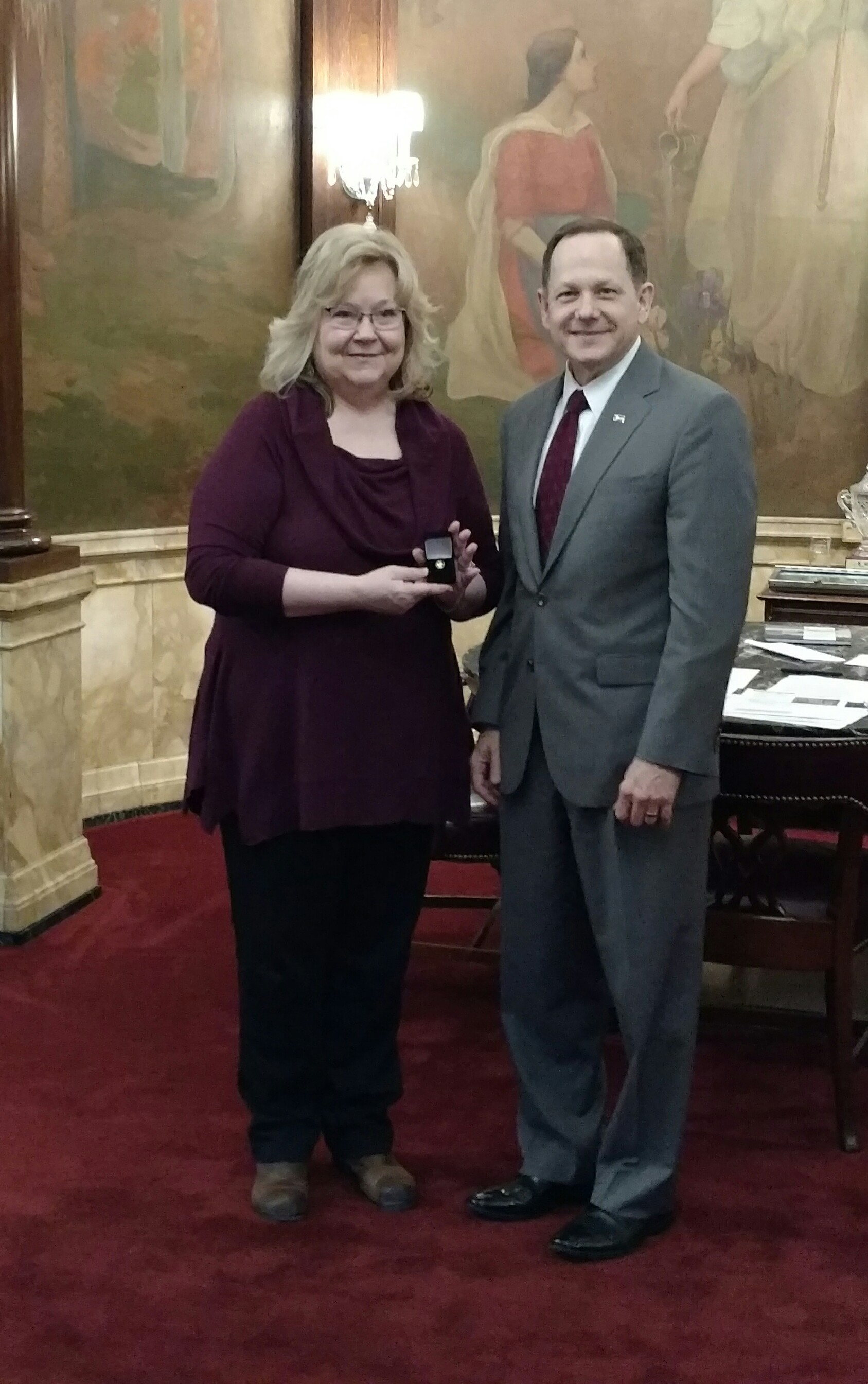 Mayor Francis Slay presents a 40-year service pin to Mary Jo Connally